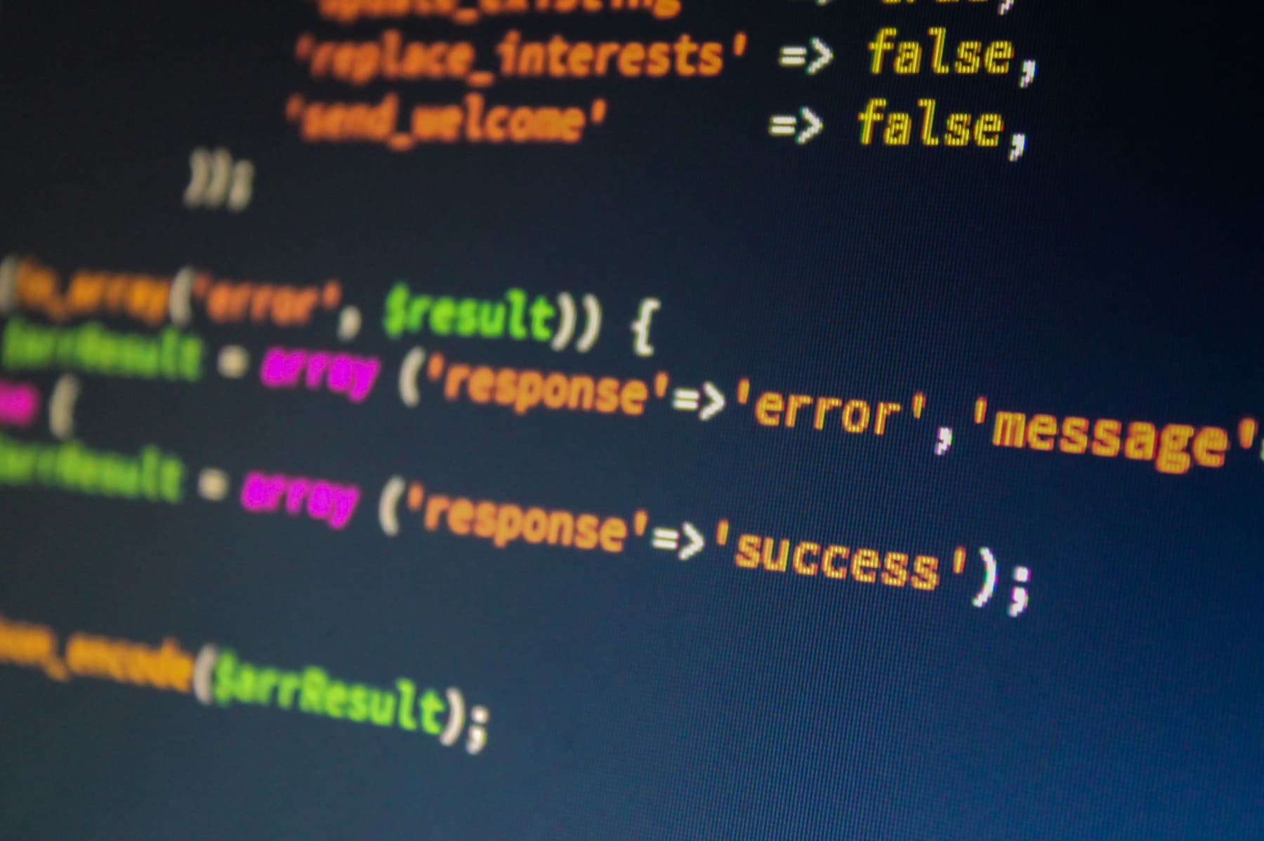 Close-up of PHP code on a monitor, highlighting development and programming concepts, along with errors.